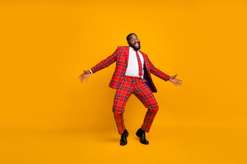 Fototapeta na wymiar Full size photo of crazy dark skin guy dance youth moves bachelor men stag party enjoy popular song wear plaid red costume blazer pants shoes isolated yellow color background
