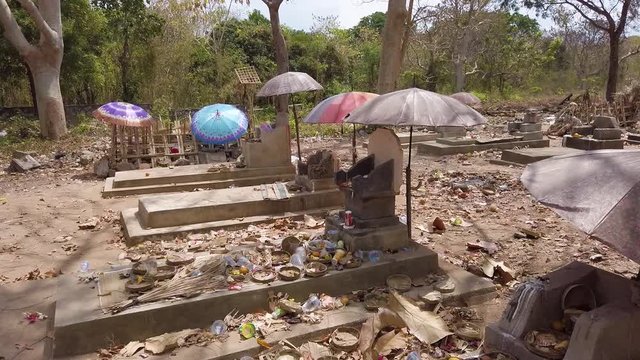 Abandoned cemetery with piles of rubish and garbage in Nusa Lembongan island, Indonesia.