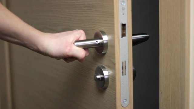 Closing the exit door slowly with regret, closeup 