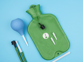 Enema, and accessories on blue background.