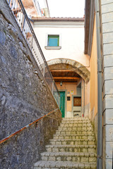 Fototapeta na wymiar Oliveto Citra, Italy, 04/08/2017. A narrow street between old buildings of a medieval village.