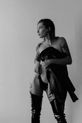 Sexy woman wearing black bikini and leather jacket