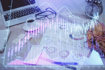 Forex market graph hologram and personal computer on background. Multi exposure. Concept of investment.