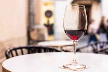 Selective focus of glass of red wine on table