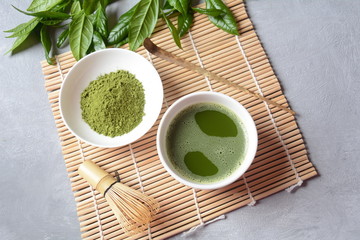 Green matcha tea drink and tea accessories on white background. Japanese tea ceremony concept. Detox tea. Antioxsidant drink