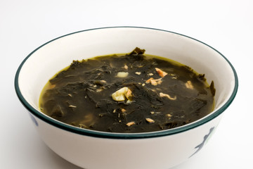 Seaweed soup in a bowl on a white background