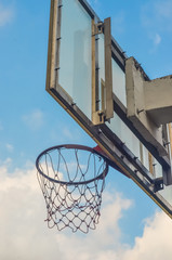 Basketball hoop with blue sky background