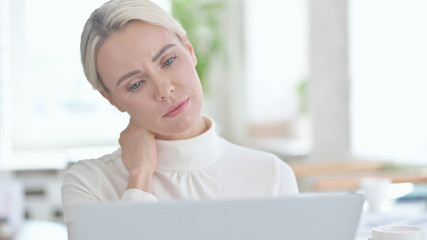 Portrait of Young Businesswoman having Neck pain in Office
