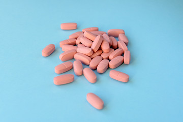 Pink pills over blue background