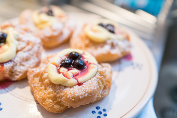 The Neapolitan pastry is called zeppola di san giuseppe, with black cherries, lemon cream with vanilla - Street Food Naples - Italy