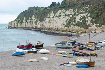 Some of the local fishing fleet stranded on the pebble beach at Beer in south Devon, UK. Vessels...