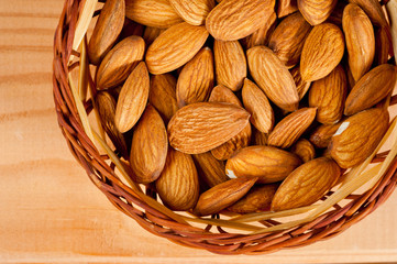 Almonds nuts shot large on a wooden background. Background for healthy eating and vegetarianism.