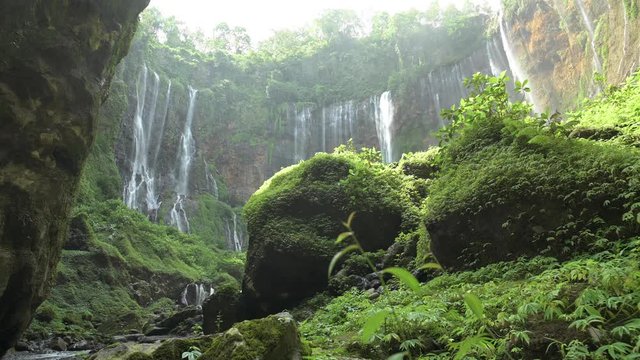 Stunning view of the Tumpak Sewu Waterfalls also known as Coban Sewu. Tumpak Sewu Waterfalls are a tourist attraction in East Java, Indonesia.