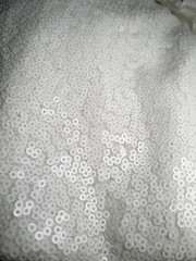 close up on shiny bridal white round sequin fabric texture detail 