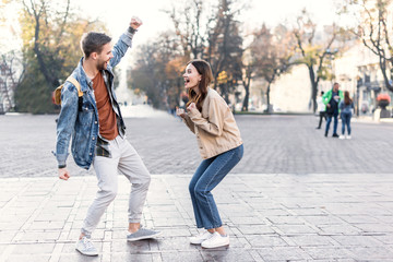 Excited woman and man looking at each other in Europe