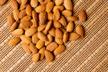 Almonds nuts shot large on a wooden background. Background for healthy eating and vegetarianism.