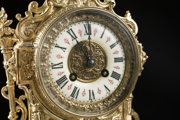 dial of vintage bronze clock, antique clock photo close up, old bronze clock in gilding, eleven o'clock on the dial, 11 am on the clock face, 11 pm hours on the dial