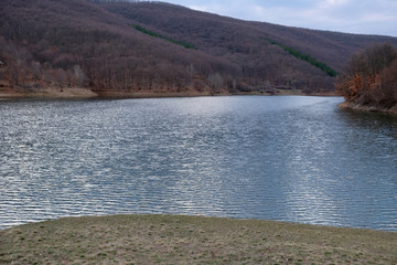 lake in the mountains and ripples in spring 