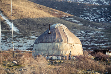 The ancient dwelling of the peoples of Asia is a yurt. In the mountains in winter. snow landscape