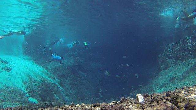 People enjoying the clear waters of Enchanted River. Enchanted river in Hinatuan, Surigao del Sur is known for its underwater cave and clear waters. It flows into the Philippine sea and Pacific Ocean.