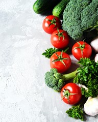 Fresh vegetables: tomatoes, broccoli, cucumbers and garlic. Healthy eating concept. Copy space