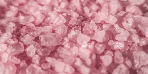 Sea salt close up as illustration of relaxing aromatherapy spa and grainy pink texture background backdrop