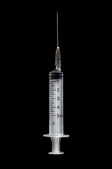 Medical syringe isolated on black background