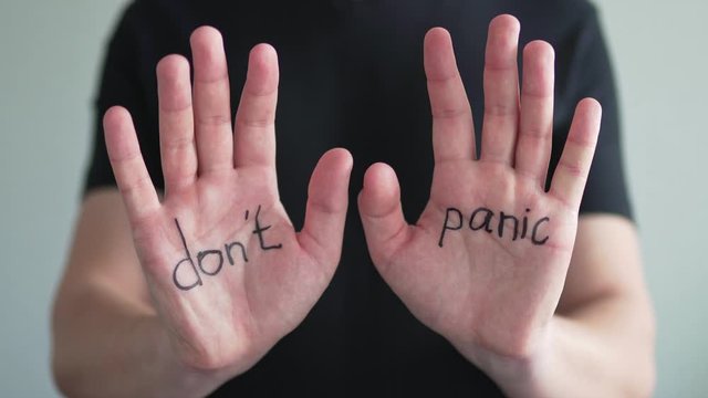 Don't panic. Text on men's hands, close-up. The concept of the coronavirus epidemic and the crisis