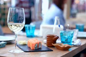 glass of white wine in the restaurant / white wine in the interior of the restaurant a table with glasses of wine, a romantic summer