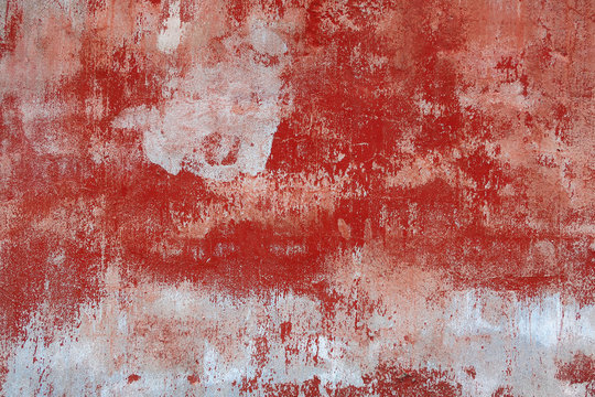 background texture of an old wall with peeling red paint