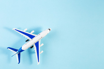 Naklejka na ściany i meble Model plane, airplane on blue pastel color background. Summer travel or vacation concept