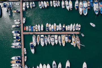 Aerial drone top down shot of a boats docked in a harbour Ischia, Italy.