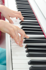 Fototapeta premium close-up of piano keys. close frontal view, black and white piano keys, viewed from side, musician hands playing piano, concept for live music festival. classical music, Instrument on stage