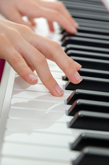 Obraz premium close-up of piano keys. close frontal view, black and white piano keys, viewed from side, musician hands playing piano, concept for live music festival. classical music, Instrument on stage
