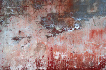 background texture of an old wall with peeling red paint