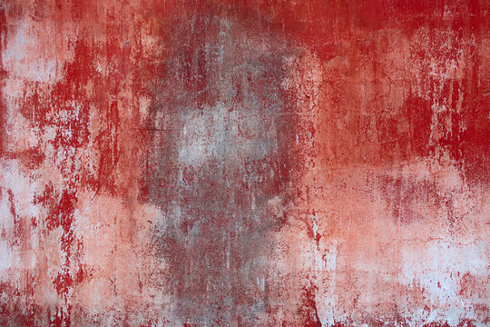 Background texture of an old concrete wall with peeling red paint