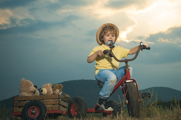 Boy to ride his bike on a country track road. Concept for safety and child development. Concept of dreams and travels.