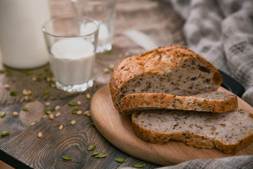 Bread and milk on planked wooden table. Horizontal shot from above.