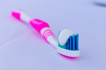 multicolored toothbrush with white toothpaste