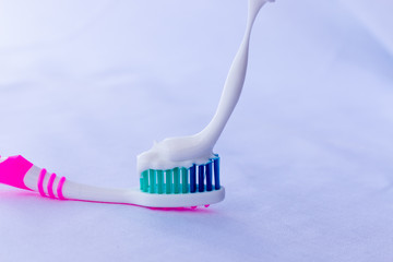 multicolored toothbrush with white toothpaste