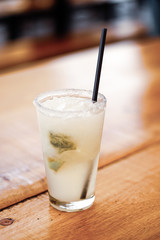 glass of cocktail on wooden background
