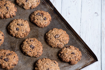 chocolate cookies on a baking tray in zenithal view and in diagonal position