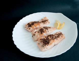 fried fish steak on a white plate