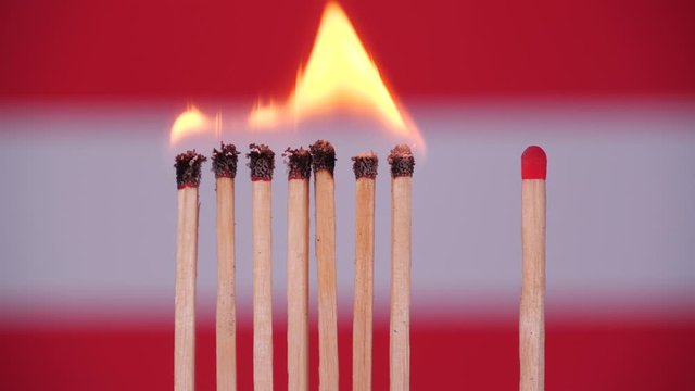 Coronavirus outbreak, social distancing in Austria. Concept: spreading epidemic, domino effect, COVID-19,  isolated burning matches, stop spreading virus