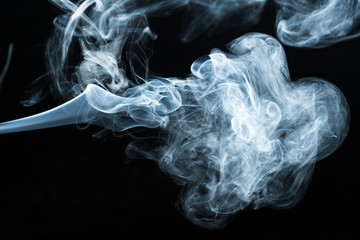 Photo of a wisp of smoke on a dark background