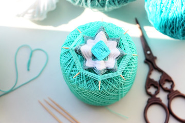 Wicker mandala made of blue yarn on wooden toothpicks. Flower pattern.