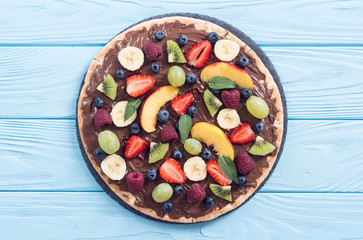 Fruit pizza with nut nougat cream , fruit and berries