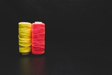 Sewing multi-colored threads on a black background
