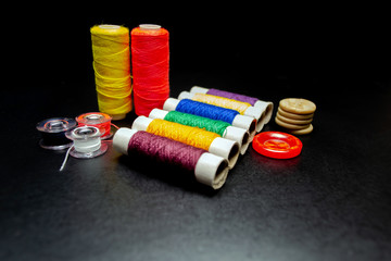 Sewing multi-colored threads on a black background