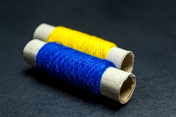 Sewing multi-colored threads on a black background
